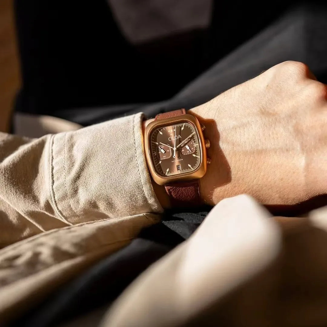 Holt square chrono watch, brown leather strap, worn on wrist in sunlight