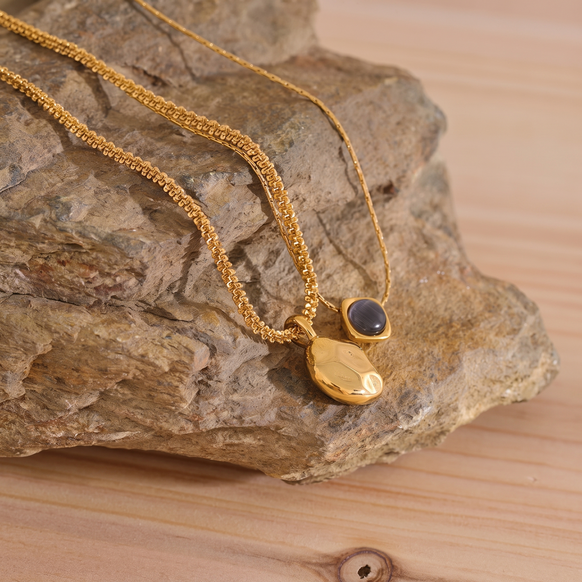 Liora Layered Stone Necklace styled on natural stone with wood accent