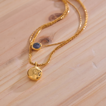 Liora Layered Stone Necklace pendant close-up on wood