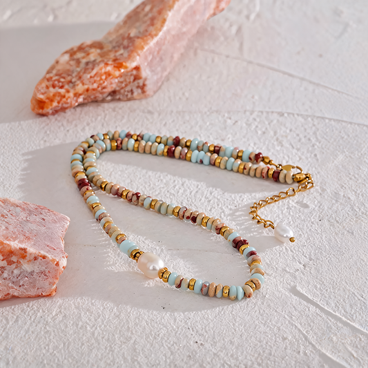 Aqua Terra beaded necklace laid flat with rough salt-rock props