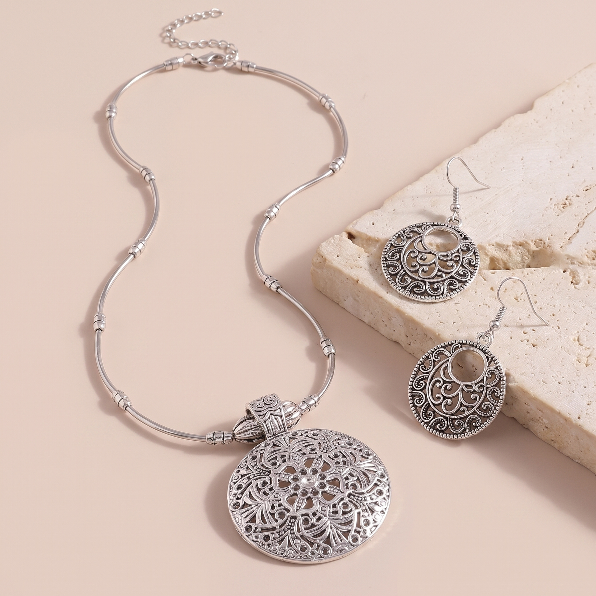 Lucca necklace laid out with the matching drop earrings