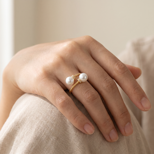 Maeve double pearl twist ring in gold, worn on hand