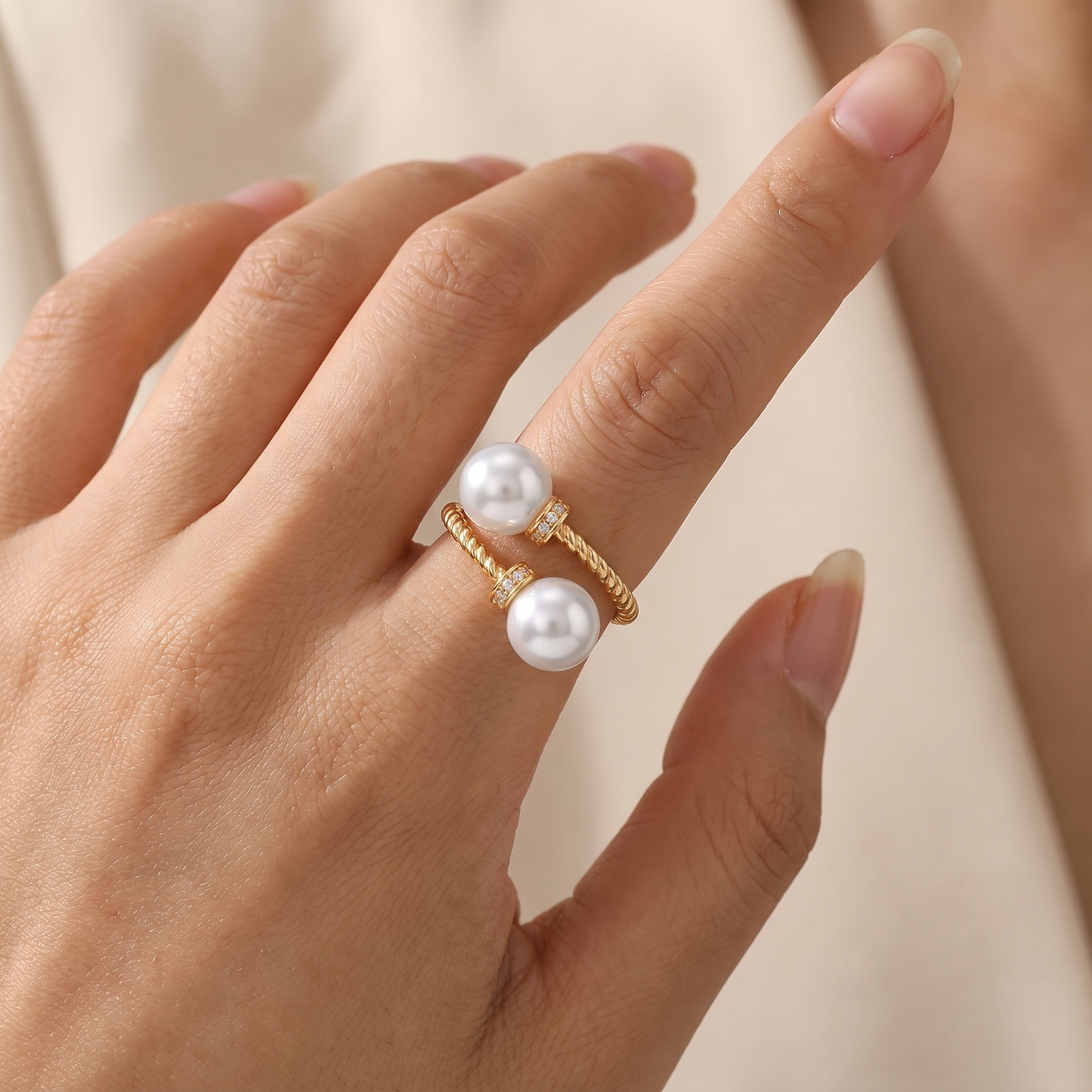 Maeve double pearl twist ring in gold, worn close-up