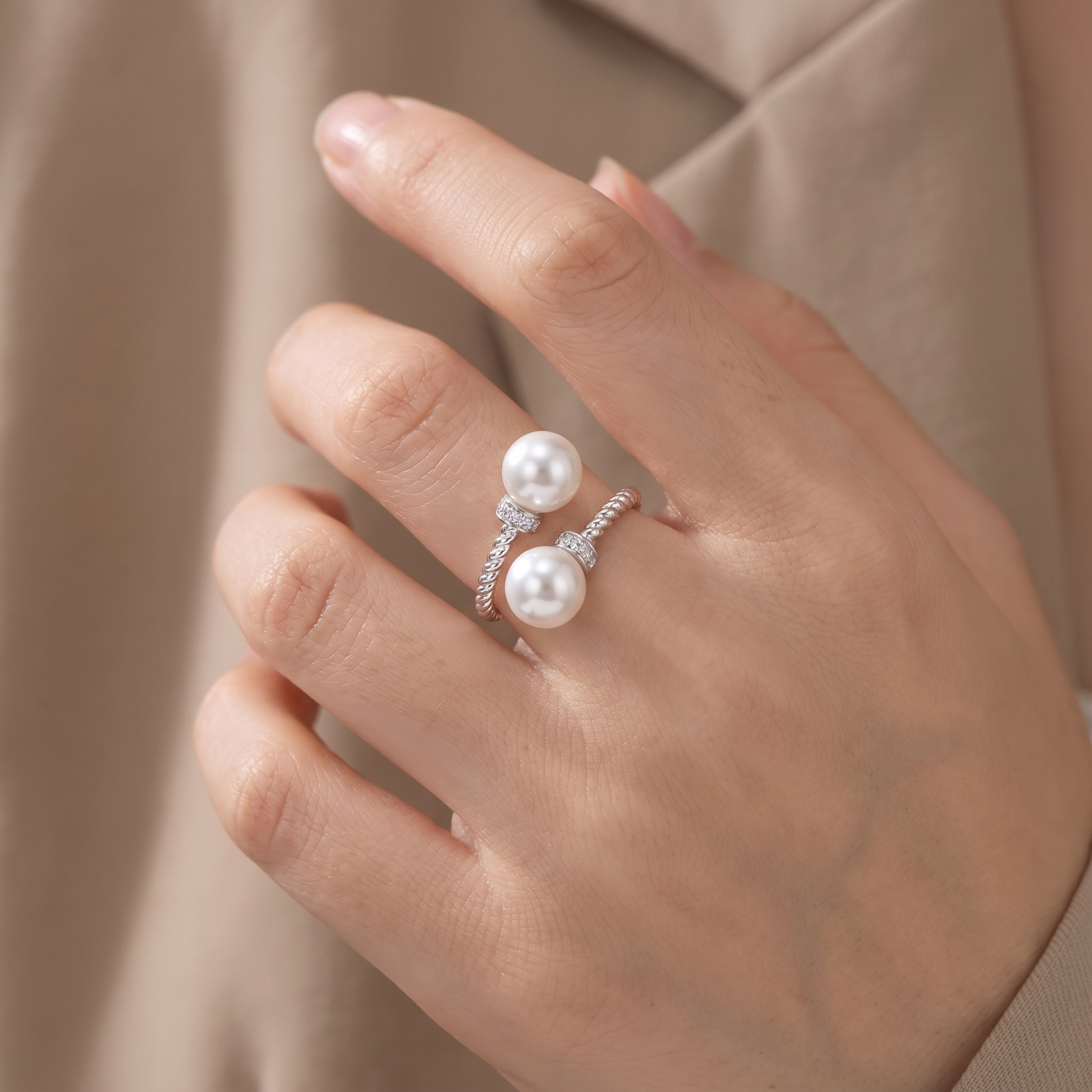 Maeve double pearl twist ring in silver, worn on hand