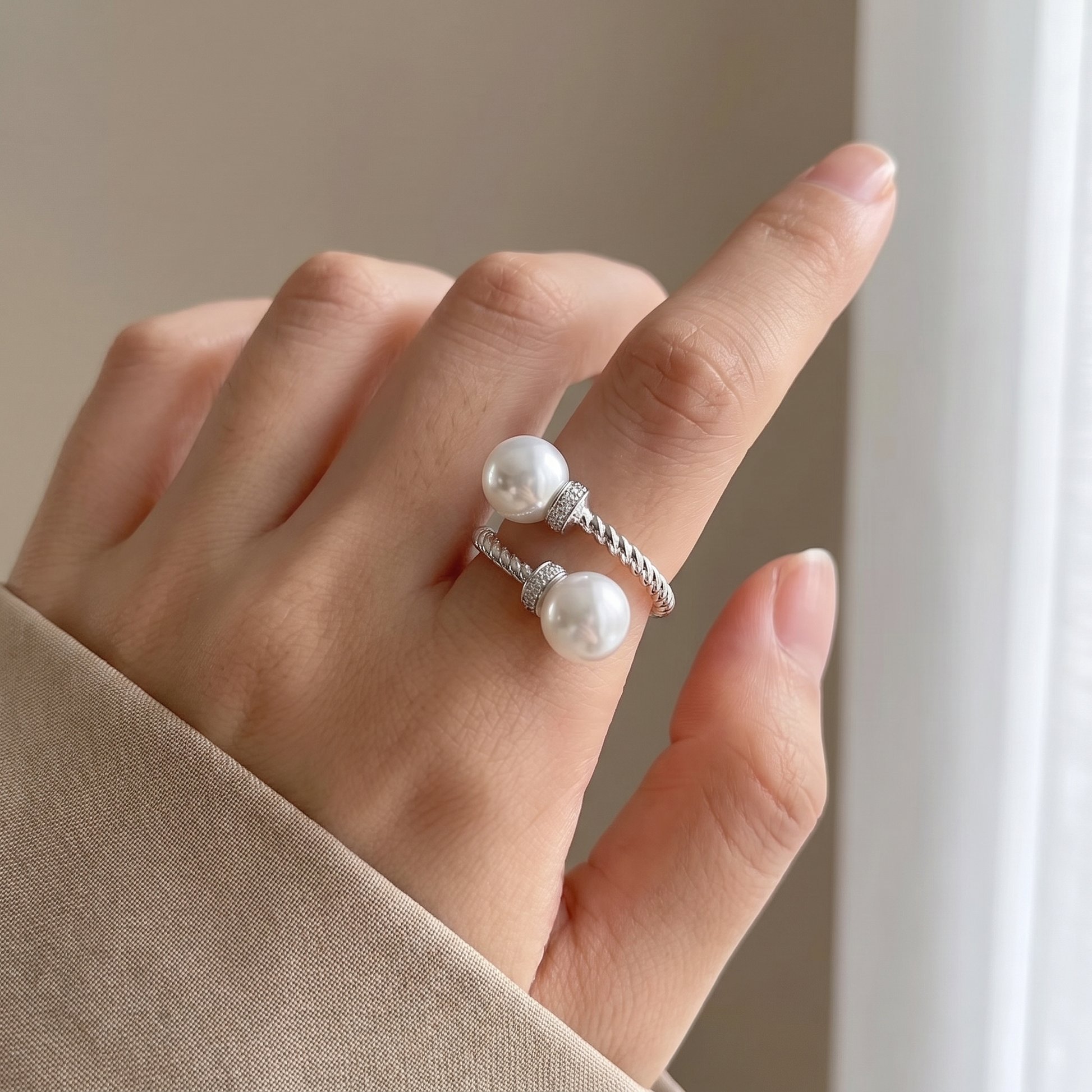 Maeve double pearl twist ring in silver, worn close-up