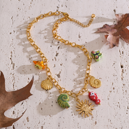 Maris Charm Cluster Necklace styled on a natural stone surface