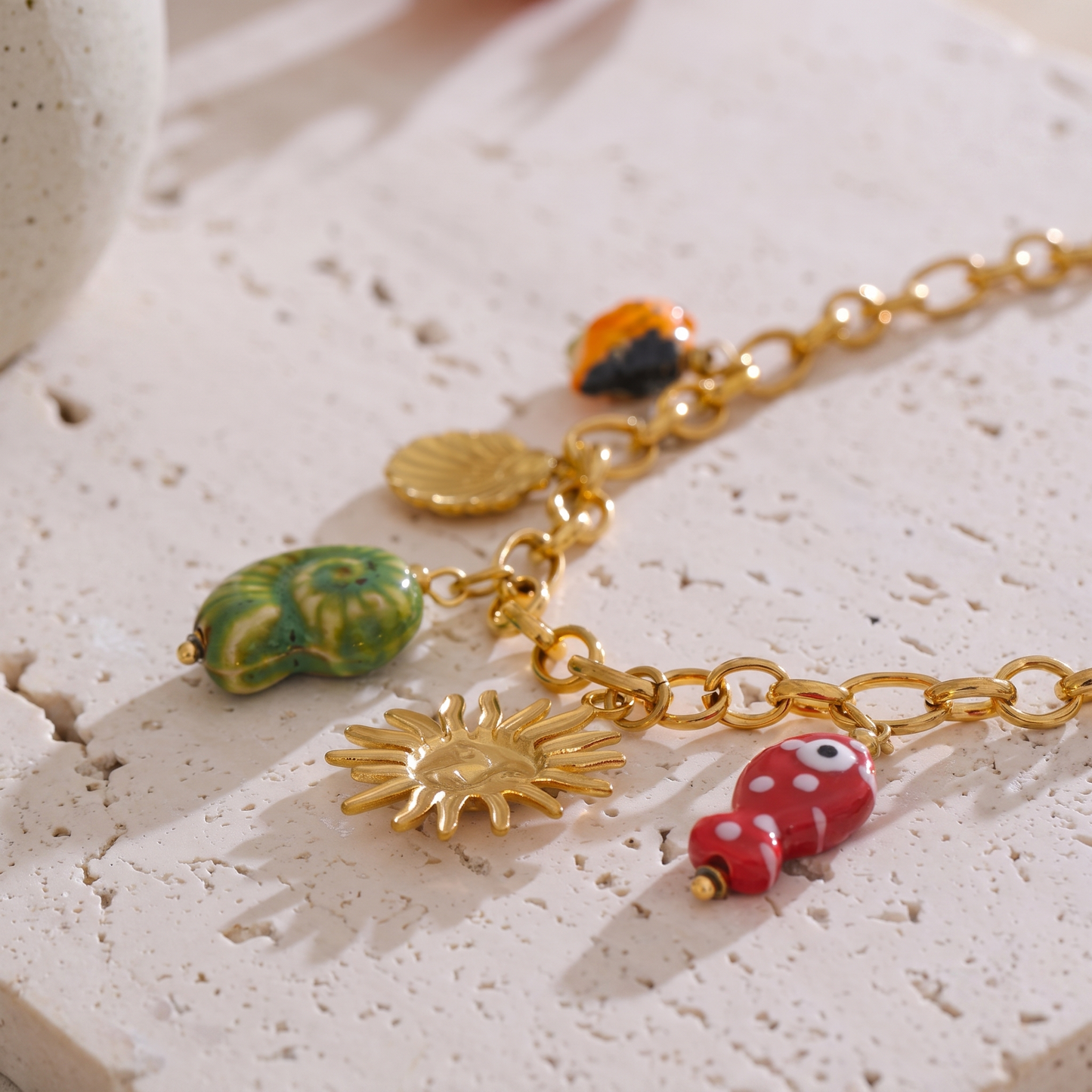 Maris Charm Cluster Necklace, close-up of the sun and shell charms