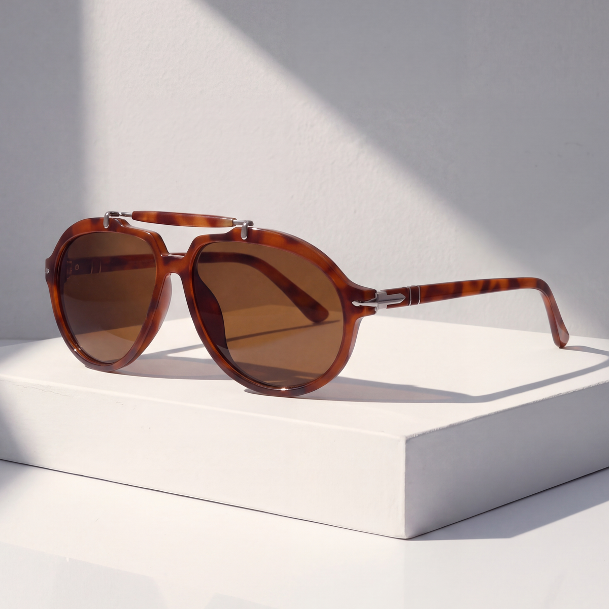 Monterey Pilot Sunglasses in Amber on a white plinth