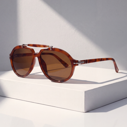 Monterey Pilot Sunglasses in Amber on a white plinth