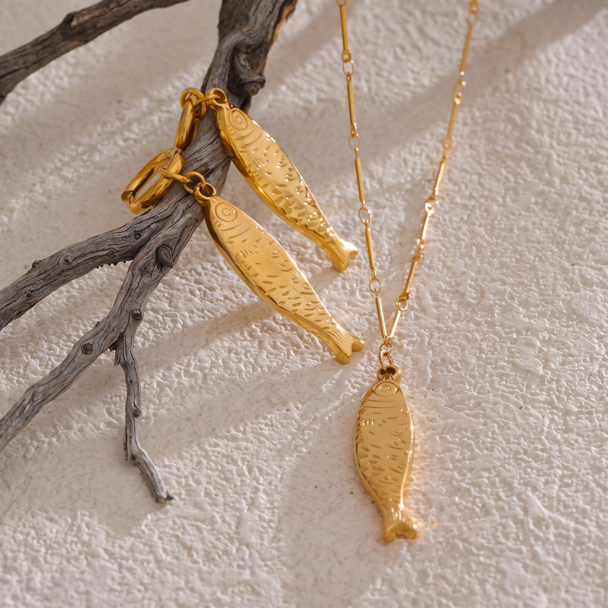 Oceane gold fish jewelry styled with driftwood