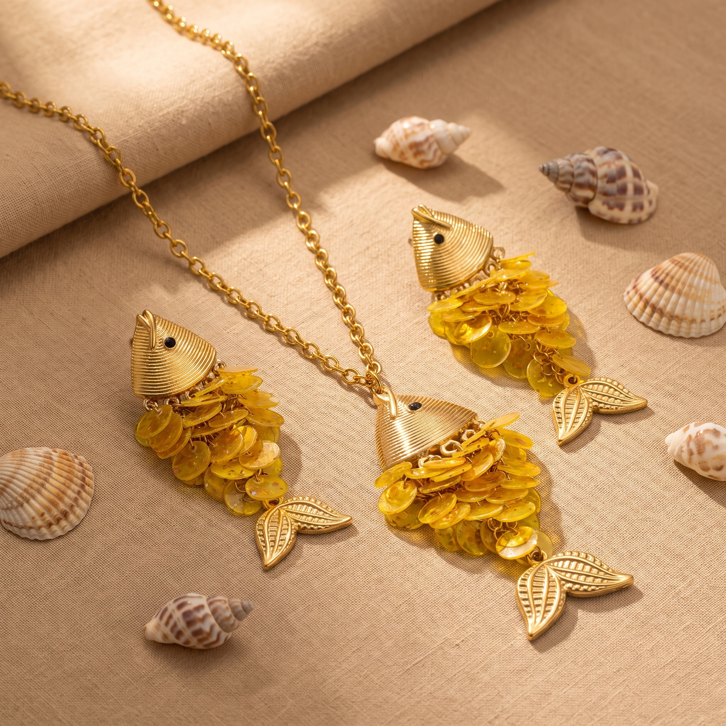Odessa golden yellow shell fish necklace and earrings styled with seashells