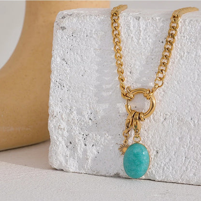 Orla Aqua Stone Necklace curb chain and aqua stone pendant styled on a textured stone block