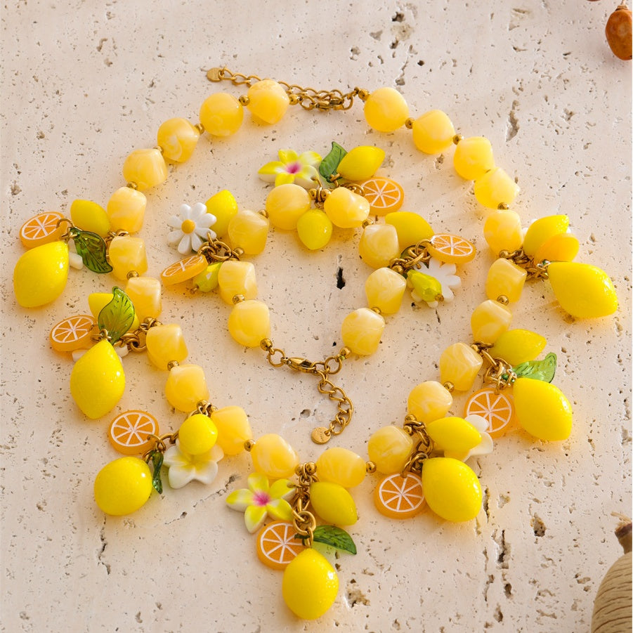Renna Lemon Jewelry Set necklace and bracelet styled on stone