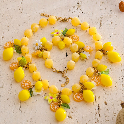 Renna Lemon Jewelry Set necklace and bracelet styled on stone