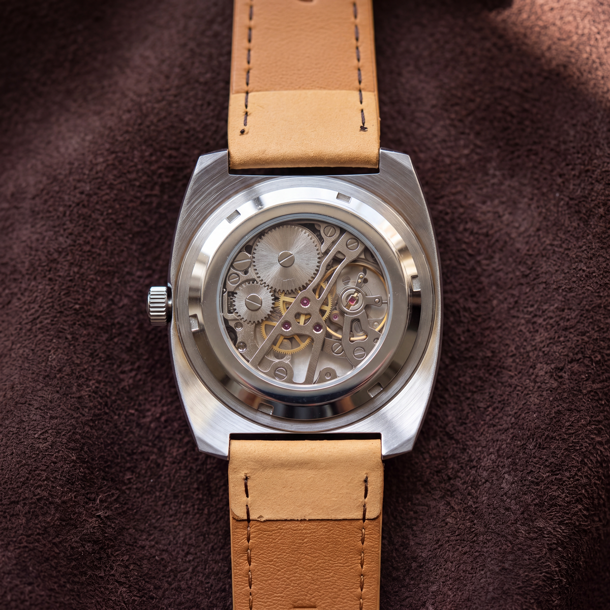 Rhodes Genuine Leather Watch caseback on brown suede, seen from above