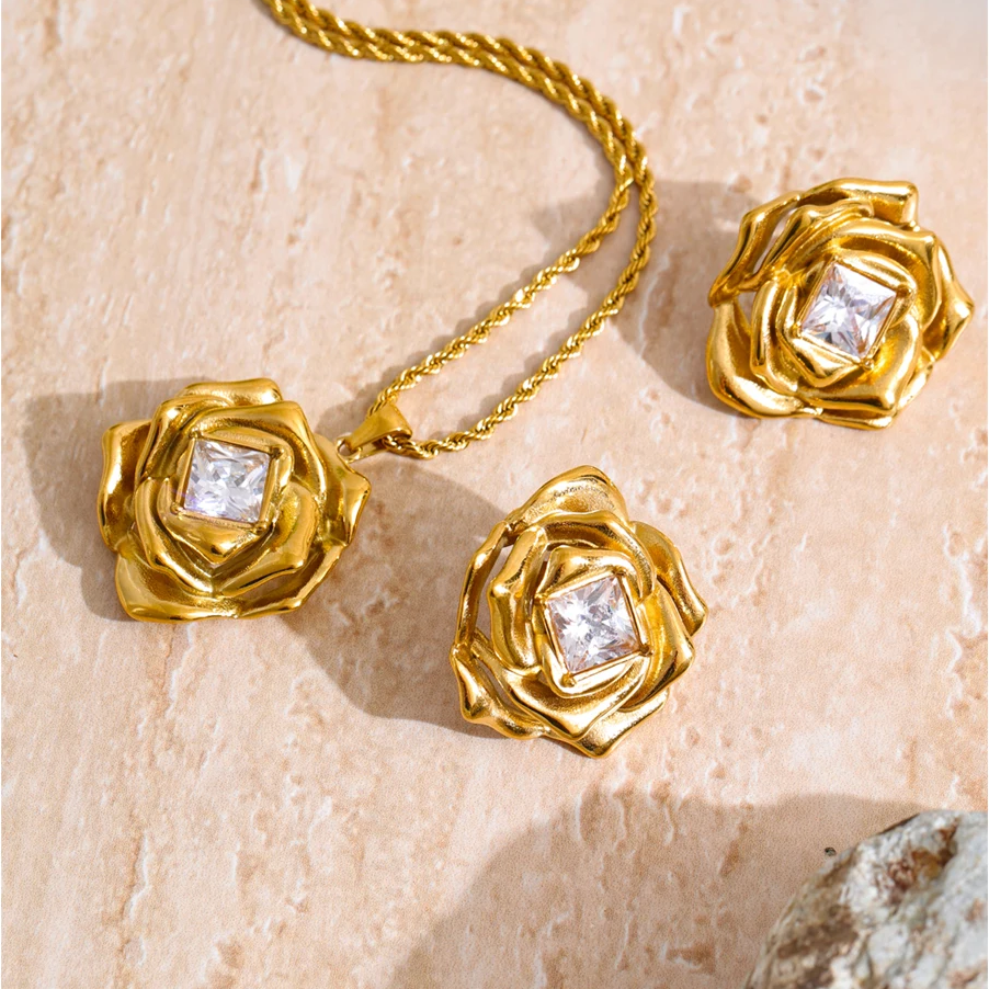 Rosalind gold rose necklace and earrings set on travertine