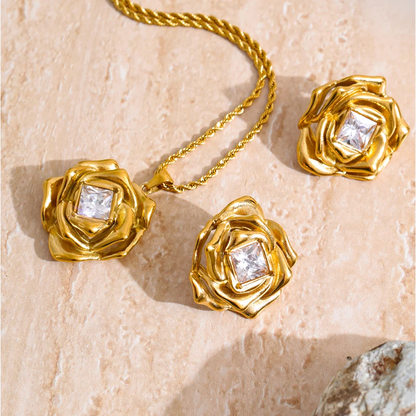 Rosalind gold rose necklace and earrings set on travertine
